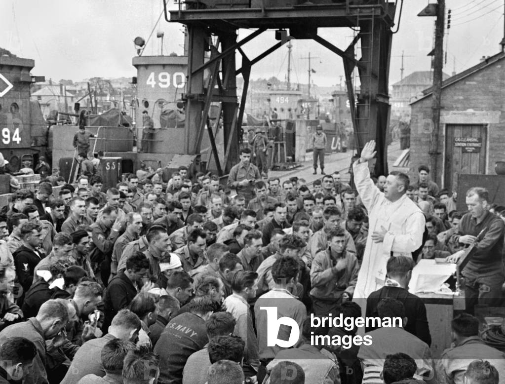 Catholic chaplain conducts services on a pier for first D-Day assault troops. Weymouth, England, June 6, 1944, World War 2