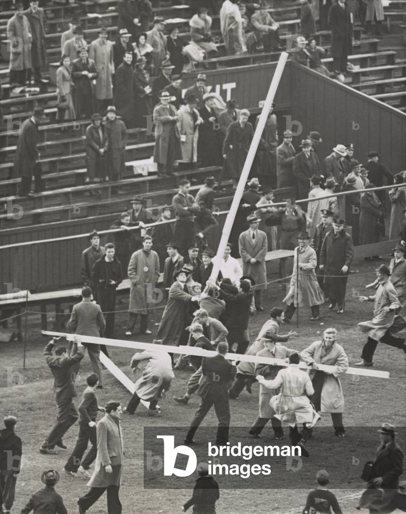 Brown University students tear down the goal posts in celebration of a 7-6 win over Columbia. Oct. 23, 1937.