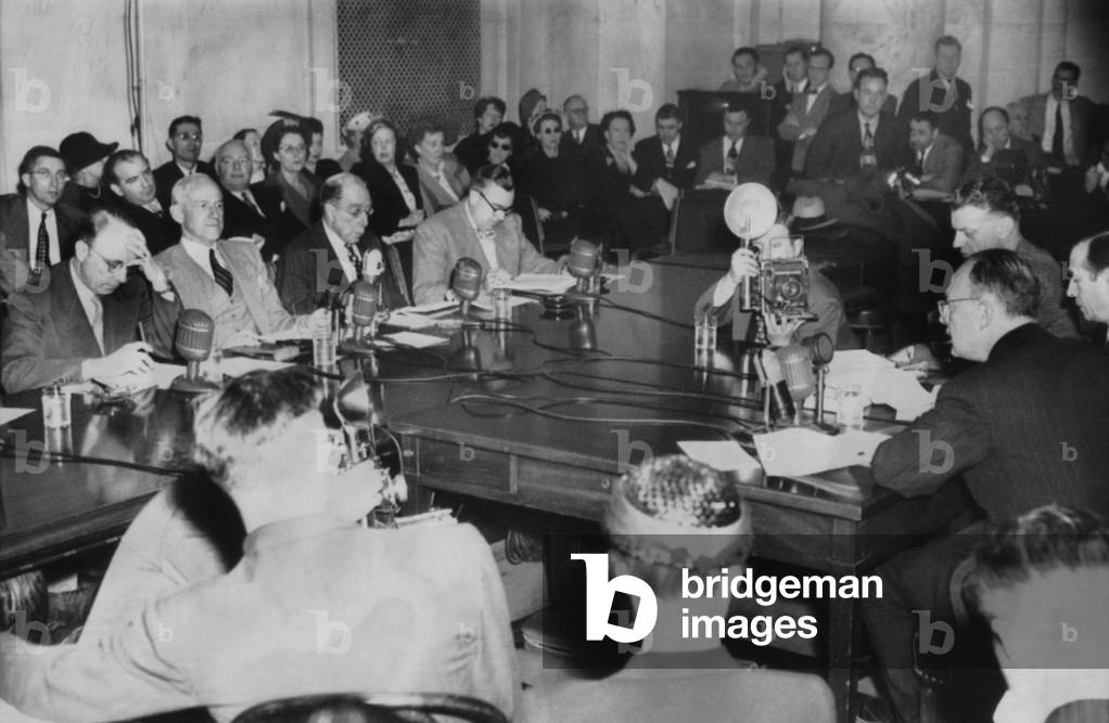 Owen Lattimore (far right) testified to Senate Tydings Committee on April 6, 1950. He swore he was never a Russian spy or a Communist, before the 'Subcommittee on the Investigation of Loyalty of State Department Employees'. Opposite Latimore are Senators Bourke Hickenlooper; Millard Tydings; Theodore Green; Brien McMahon. Sen. Joseph McCarthy is in second row