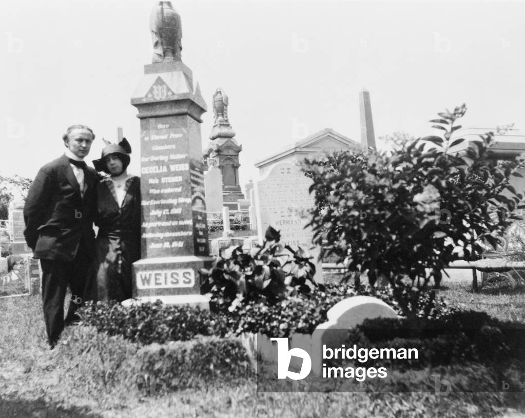 Bess and Harry Houdini at his beloved mother, Cecilia's grave. After her death, Houdini exposed the methods of spiritualist who preyed upon the grief of the bereaved. c. 1915