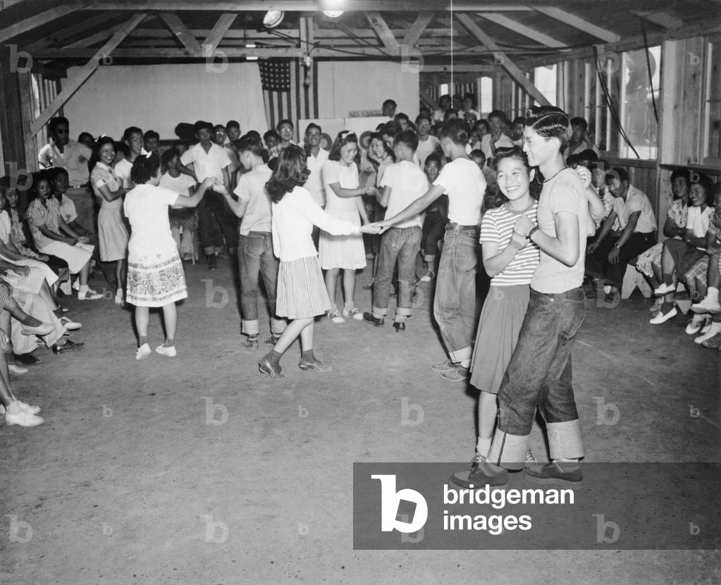 Young Japanese-Americans dancing at the Fresno, California, Assembly Center in 1942. Assembly centers were the initial organizing points, from which internees were taken to the relocation camps that would be their homes for the duration of World War II