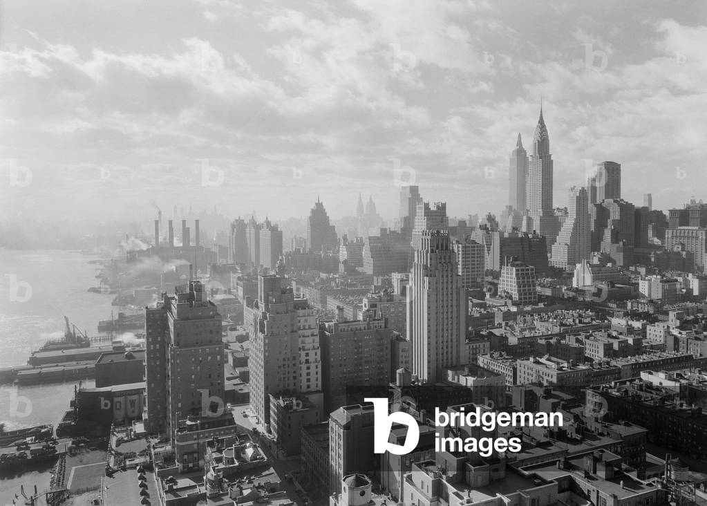 View of Midtown Manhattan from the 27th floor of 'River House', a prestigious apartment building. Dec. 15, 1931. At this time block near the East River were undesirable, with docks, meat processing plants, and the large Edison power plant. Photo by Samuel H. Gottscho