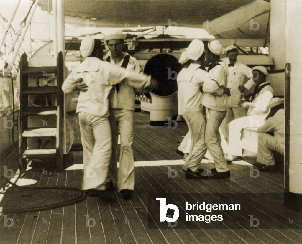 Sailors aboard the USS OLYMPIA waltzing at tiffin (lunch time), 1899. The USS OLYMPIA was Admiral Dewey's flagship and is now a museum ship at the Independence Seaport Museum, Philadelphia