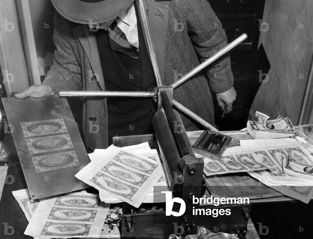 Police seized ,000,000 counterfeiting ring. Bogus money, printing plates and printing press were seized by secret service agents and Police, when they arrested six men and two women at 224 West 13th street, NYC. March 6, 1939