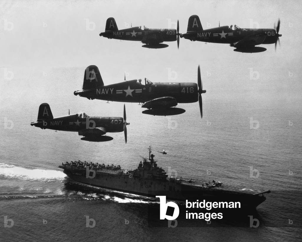 F4U's (Corsairs) returning from a combat mission over North Korea to the USS Boxer. Planes in the next strike are about to be launched from the carrier flight deck. Sept. 4, 1951. Korean War