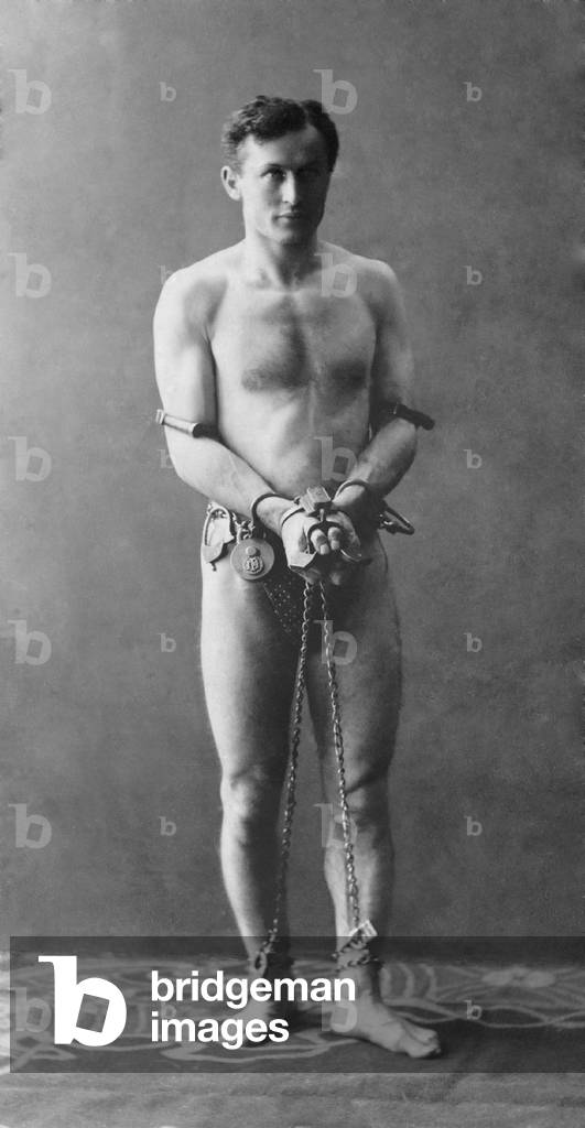 Harry Houdini (1874-1926), in chains. c. 1900