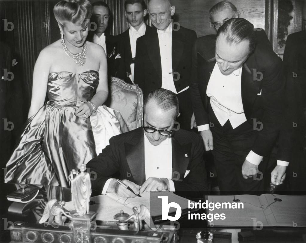 The French-Argentine Treaty of Commerce is signed in Paris, July 24, 1947. Before the signing are, L to R: Foreign Minister Georges Bidault, Eva Peron, and Julio Victorica Roca, Argentine Ambassador to France. July 24, 1947.