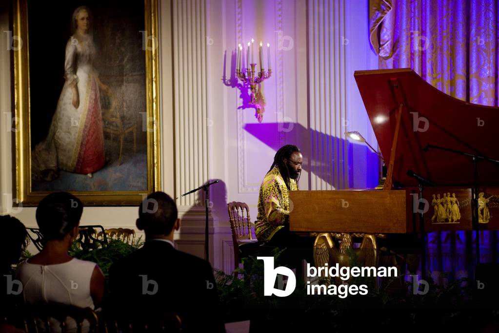 Concert pianist Awadagin Pratt performs at the White House on Nov. 4 2009. The African-American classical virtuoso's dreadlocks and colorful clothing reduce barriers with the audience and young people. President and Michelle Obama listen at lower left.,