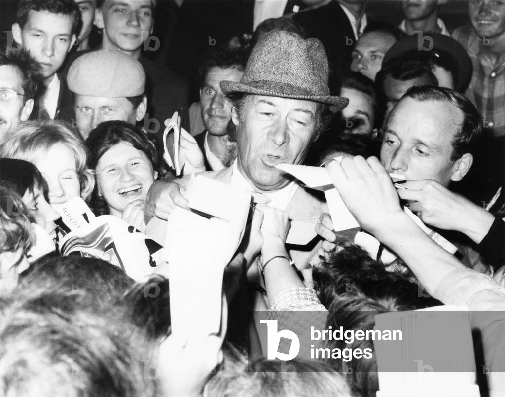 British Actor Rex Harrison stepped into a swarm of Russian autograph seekers outside his hotel. Harrison was in Moscow for a film Festival. July 24, 1965