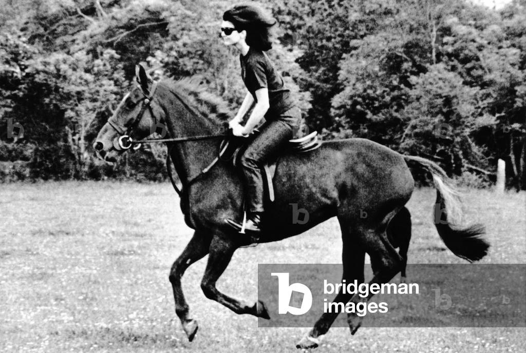 Jacqueline Kennedy, riding a horse in Waterford, Ireland, 1967 (b/w photo)