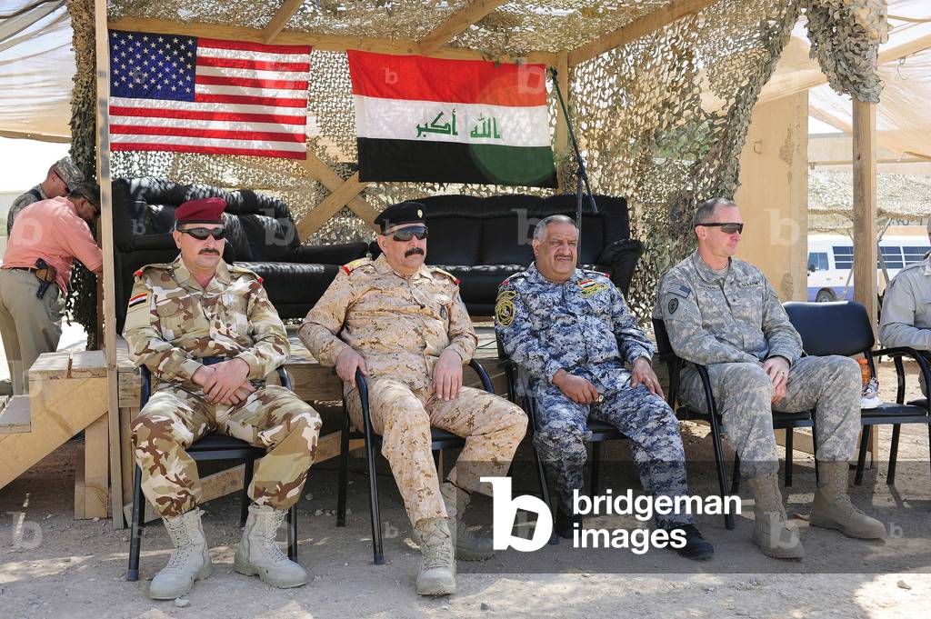 U.S. Army Brig. Gen. Robert Brown right of Multi-National Division watches an exhibition soccer game with Iraqi military leaders during Iraqi Security Forces training. Oct. 6 2009., Photo by:Everett Collection