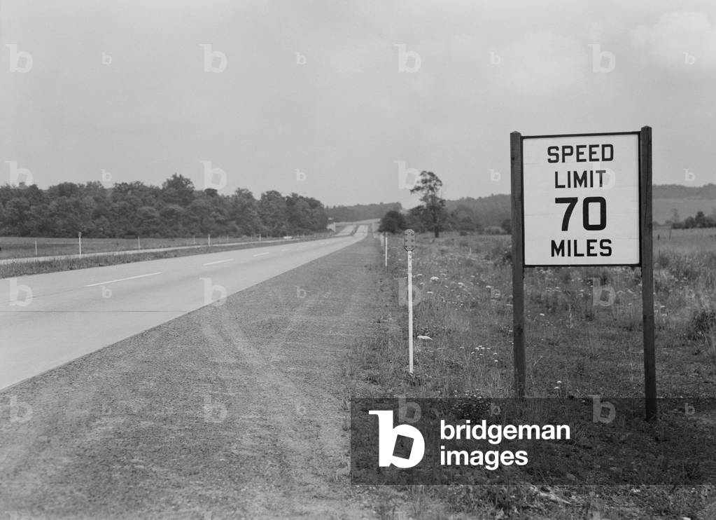 70 MPH speed limit sign on the empty Pennsylvania Turnpike during World War 2. Before the war, the Turnpike has no speed limits. Sept. 1942
