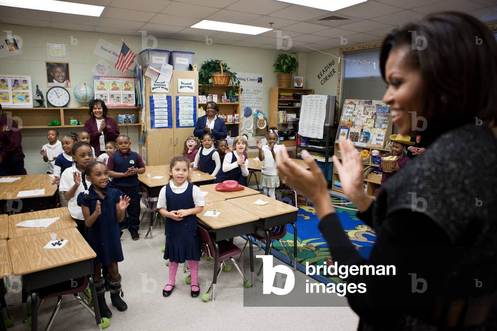 First Lady Michelle Obama claps along with students as they sing during her visit to Burgess-Peterson Academy in Atlanta Georgia Feb. 9 2011.,