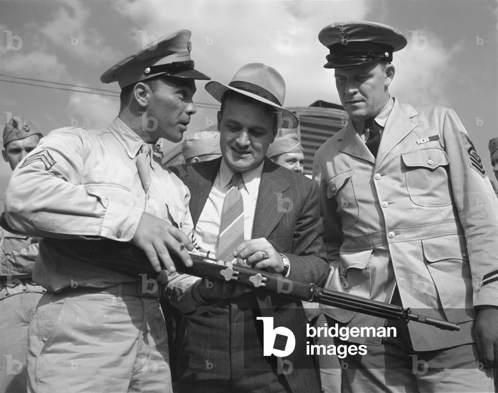 World War II, French L. Vineyard (left), at his army post, where welder George Woolslayer (center) and Aviation-radio Chief John Marshall Evans (right) learn about life in the Army, Pittsburgh, Pennsylvania, photograph by Alfred T. Palmer, August, 1942