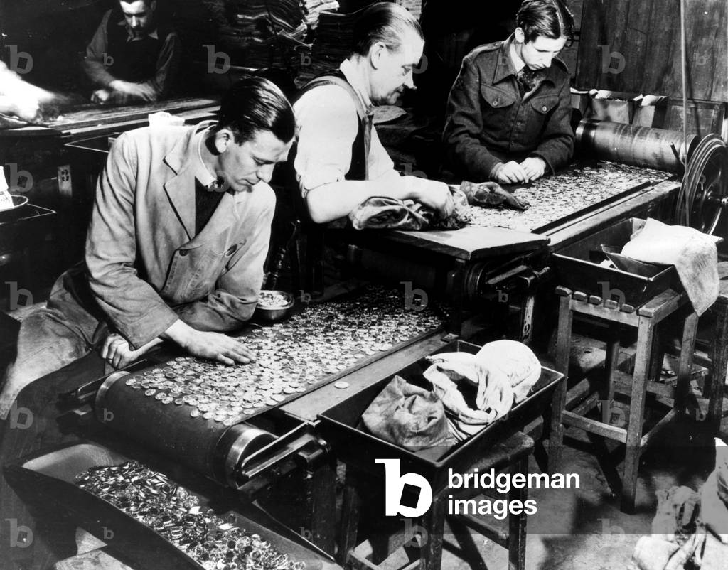 Workers inspect finished coins at the Royal Mint during a monetary shortage. 1948.