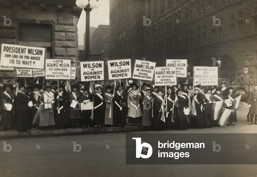 Crowd of women's suffrage supporters demonstrating with signs reading, 'Wilson Against Women,' in Chicago on October 20, 1916. Wilson withheld his support for Votes of Women until 1918
