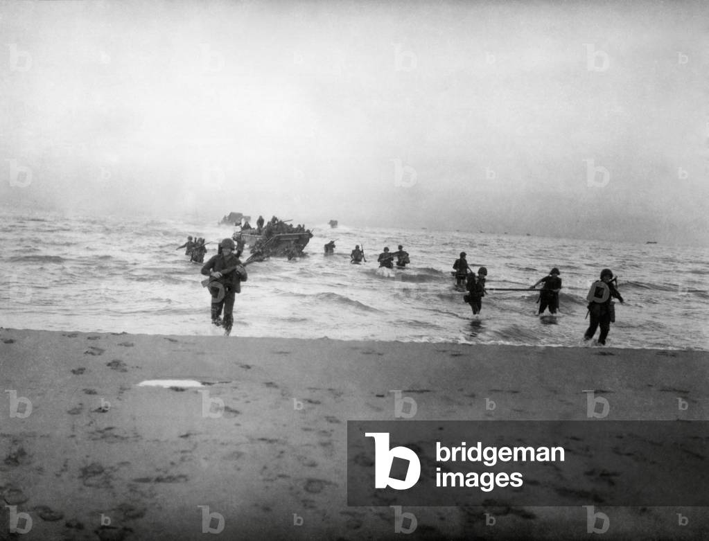 143rd Infantry regiment Combat Team running onto a beach on the Gulf of Salerno, Italy. Sept. 9, 1943, World War 2