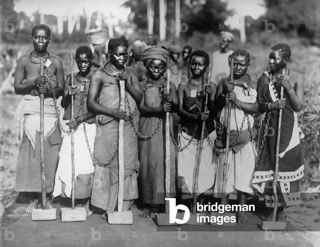 Women convicts working on road while chained together by neck rings in Tanganyika, East Africa c. 1915