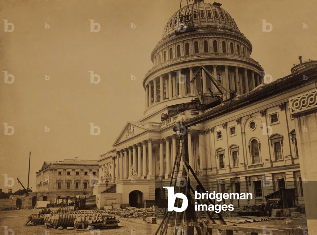 United States Capitol Building in 1863, showing the dome under construction. In the foreground are pre-formed cast-iron metal facings for the new dome. Photo by Andrew J. Russell