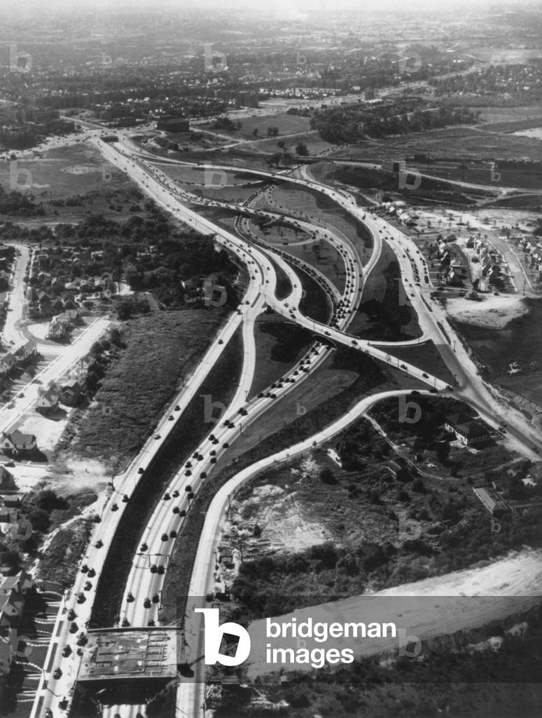 Aerial view of limited access highway on Long Island. The new roads provide access from the growing suburbs to New York City. c. 1946