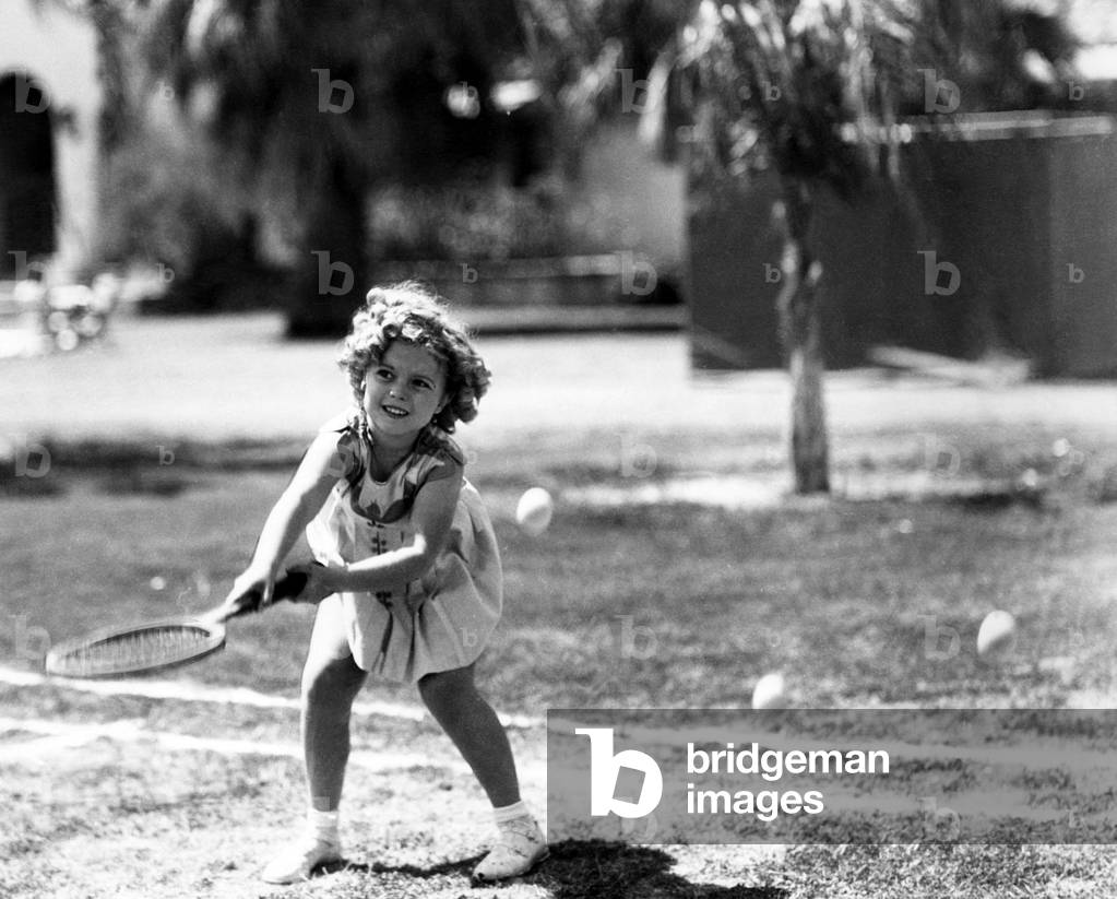 Shirley Temple, American actress, playing tennis, July 27, 1936