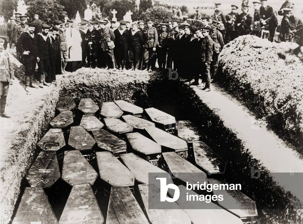 Clergy and military witness the common grave burial of Lusitania victims, in Ireland, after their recovery from sea. 1915