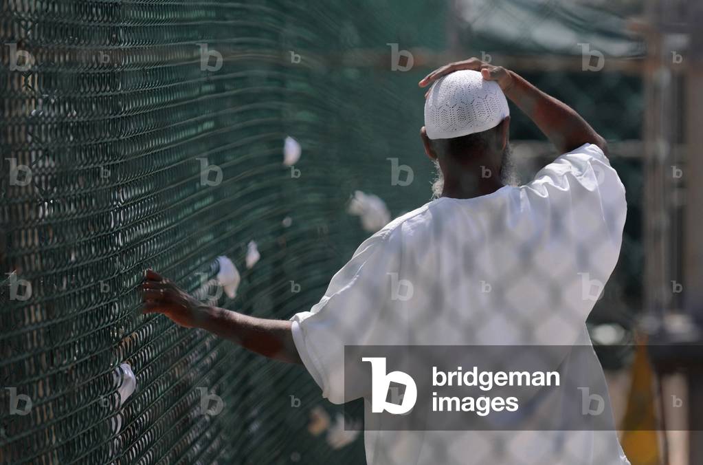 In Camp Delta prison at Guantanamo Bay Naval Base Cuba a detainee stands in the recreation yard. June 8 2010., Photo by:Everett Collection