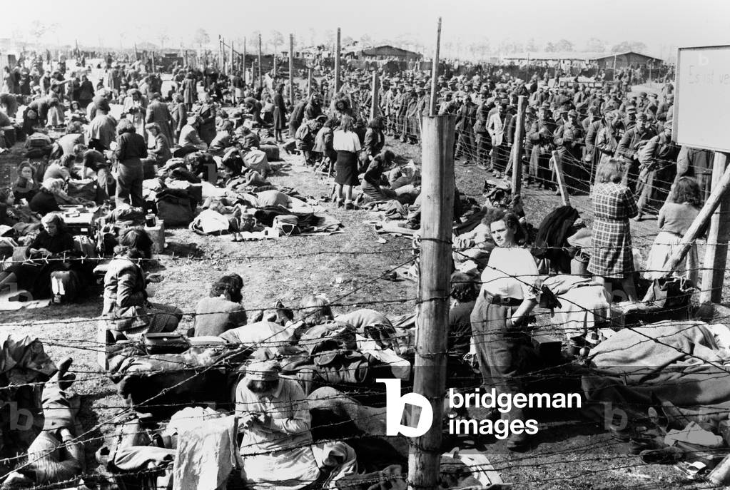German women in a POW enclosure, separated from that of the male prisoners. They are inmates of prisoner of war enclosure at Regensburg, Germany. May 8, 1945 during World War 2