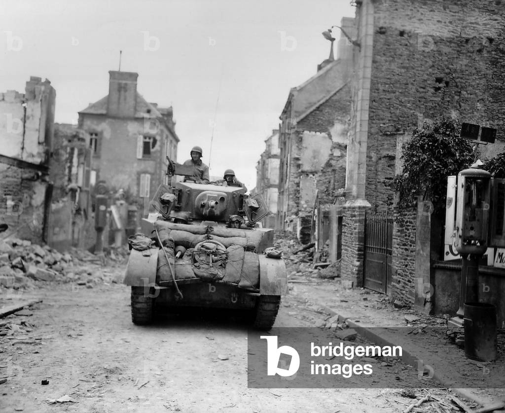 U.S. tank advancing through the ruins of Saint Lo, July 19, 1944. The Norman town was a hub of main roads that lead in every direction on the Lower Normandy peninsula. France, World War 2