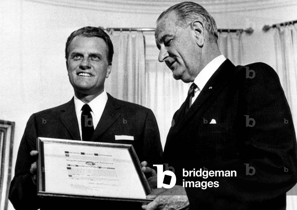 President Lyndon Johnson presents the annual 'Big Brother of the Year' award to evangelist Billy Graham. May 10, 1966.