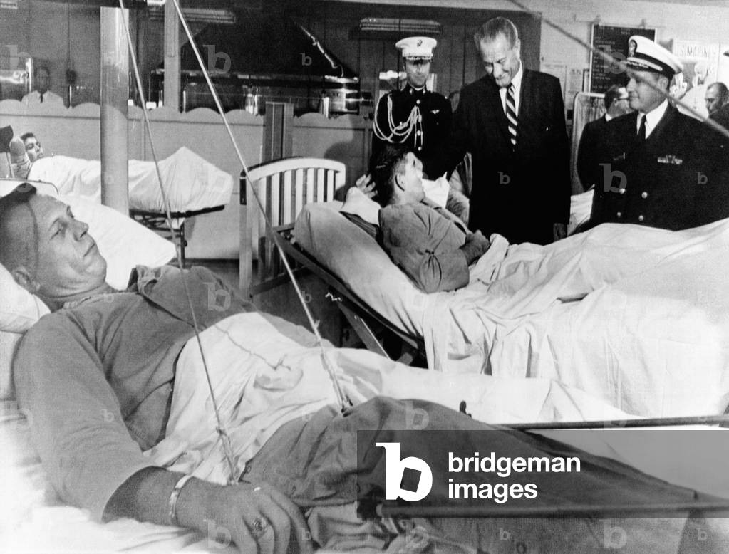 President Lyndon Johnson visits Vietnam wounded. Johnson chats with Cpl. Ronald Ortiz as 1st Lt. Bernard VeRonin, lying in traction in the foreground, awaits his turn. Camp Pendleton, Calif. Nov. 10, 1967