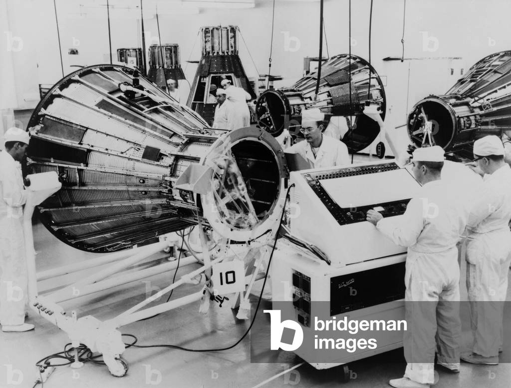 Workmen assemble Project Mercury space capsules for American astronauts, at McDonell Aircraft Corporation, St. Louis, Missouri in 1961