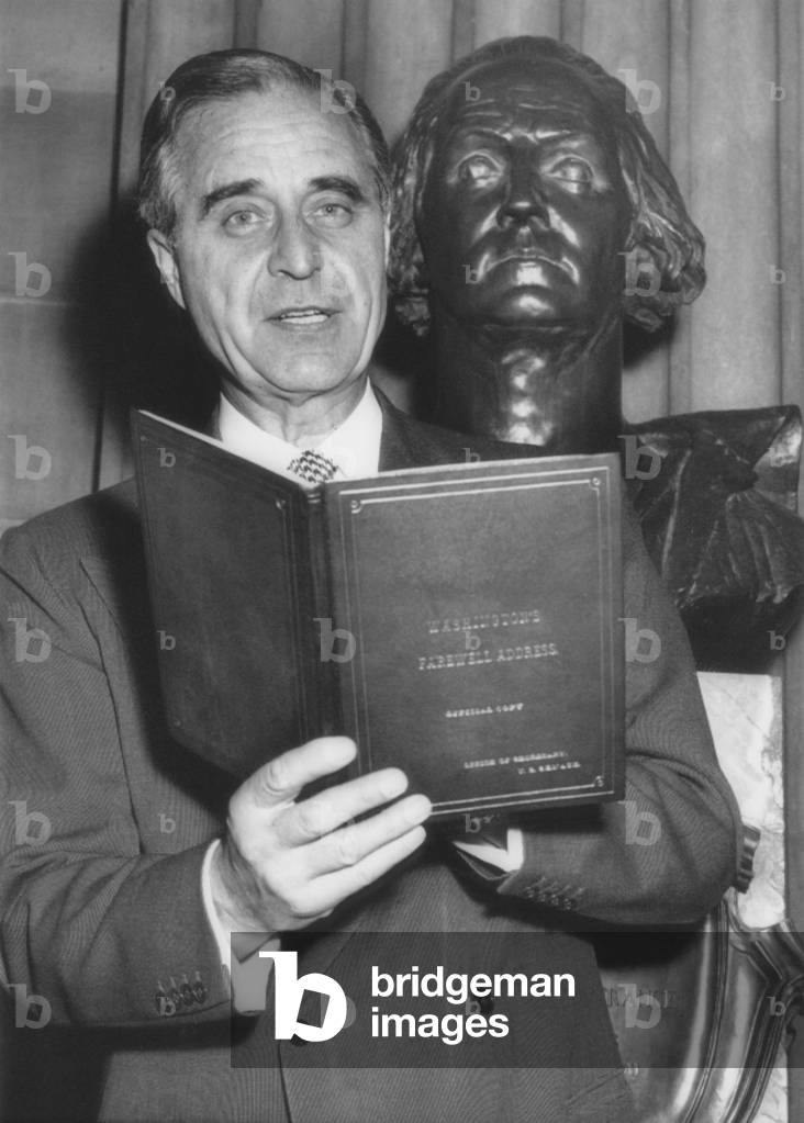 Senator Prescott Bush observes George Washington's birthday at the Capitol in 1955. Posing in front of statue of Washington, he holds the copy of Washingtons Farewell Address, which he read in the Senate chamber