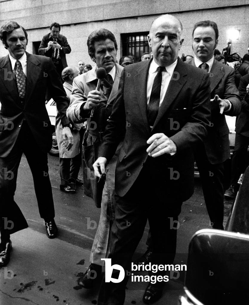 Former Attorney General John Mitchell leaving Federal Court where he pleaded not guilty to charges of perjury and conspiring to obstruct a Federal investigation of Presdient Nixon. May 21, 1973