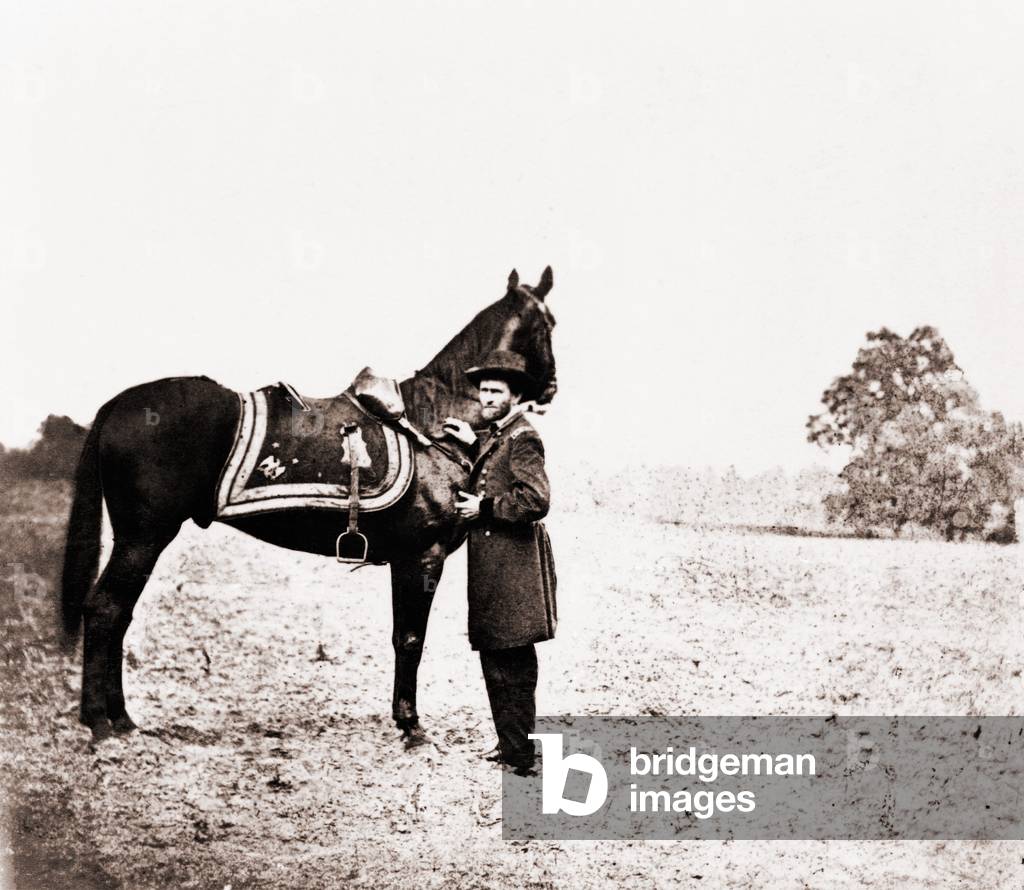 Union general Ulysses S. Grant (1822-1885), standing alongside his war horse, Cincinnati. June 4, 1864