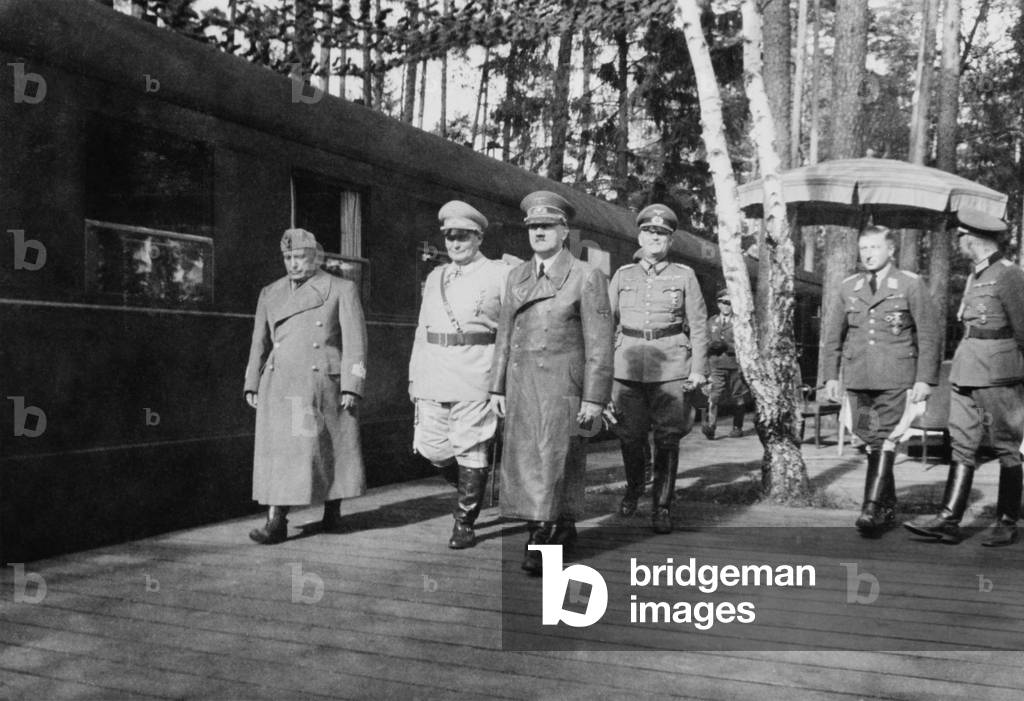 Adolf Hitler, Hermann Goering, and Benito Mussolini. They walk with other German military officers at railroad station, on Mussolini's departure from Anlage Sud (Installation South) Strzyzow, Poland. Aug. 26, 1941