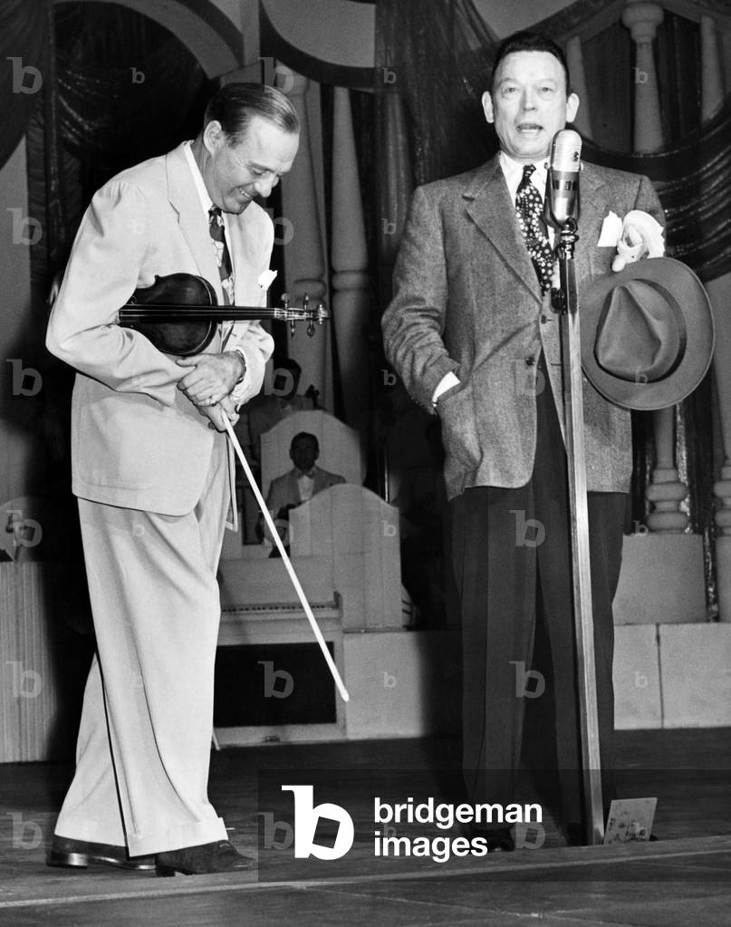 Fred Allen (right) interrupts Jack Benny's performance at the Roxy Theatre in New York, 1947
