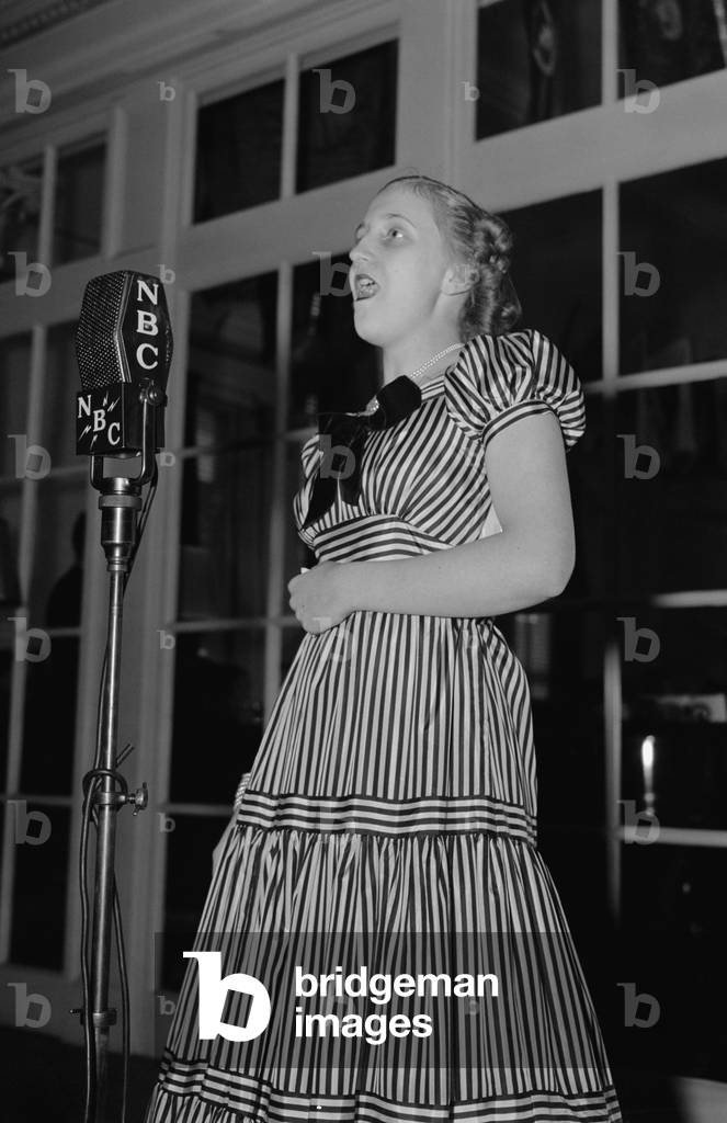 Margaret Truman, singing into a NBC Microphone, May 4, 1939. The daughter of Missouri Senator, Harry Truman, was at the third annual Congressional Children's Broadcast