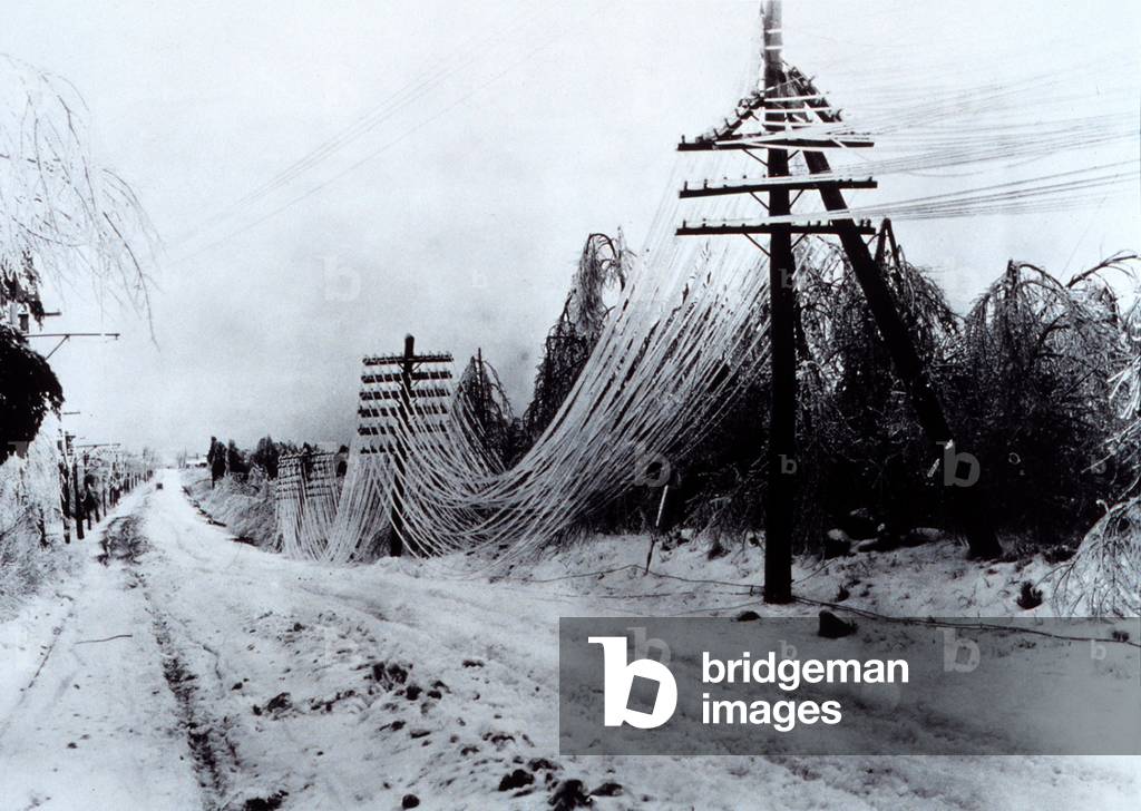 Power and telephone lines sagging after heavy ice storm. c. 1920-1950