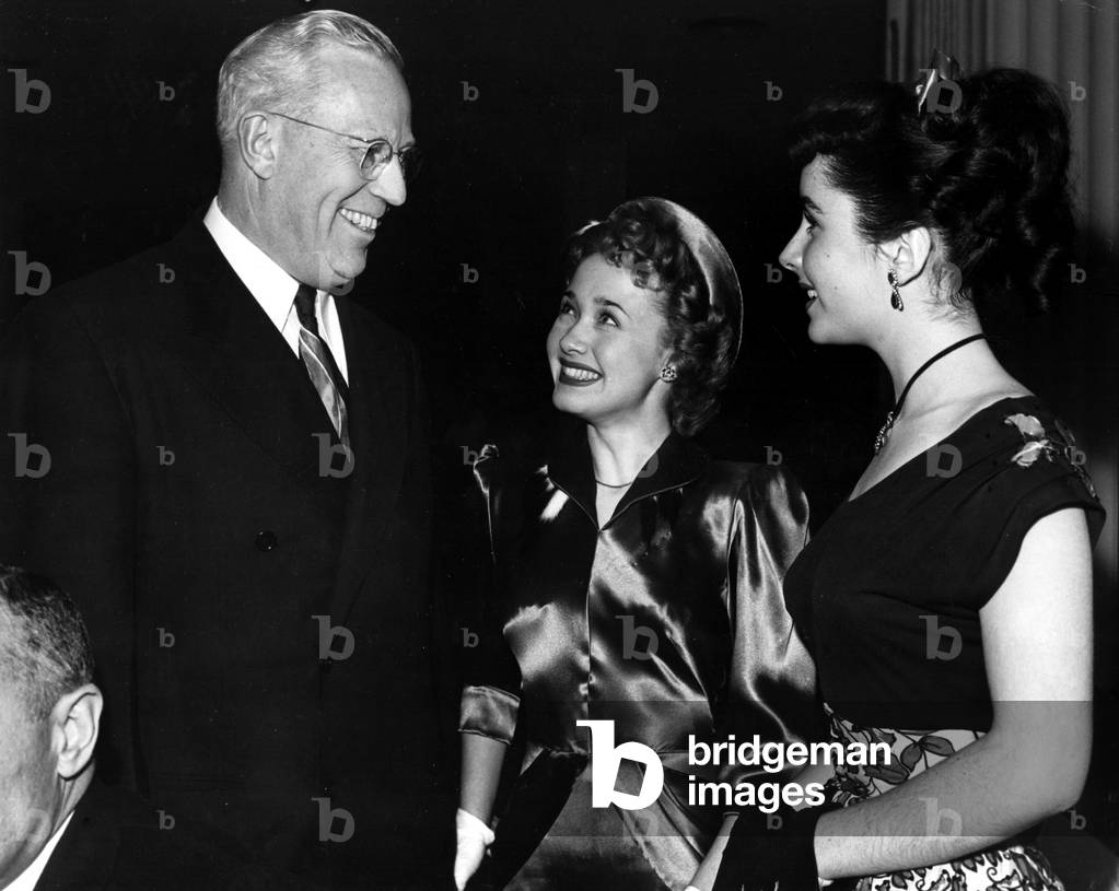 Governor EARL WARREN rubs elbows with JANE POWELL and ELIZABETH TAYLOR at the Look Award Party, Beverly Hills Hotel, 1947