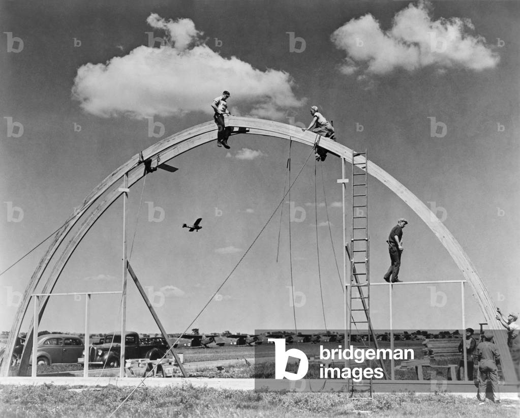 Construction workers on airplane hangar with prefabricated 'Rilco' glued laminated wooden arches. The arch of the Morey Airplane Hangar has a span of 70 feet. Janesville, Wisconsin, c. 1942