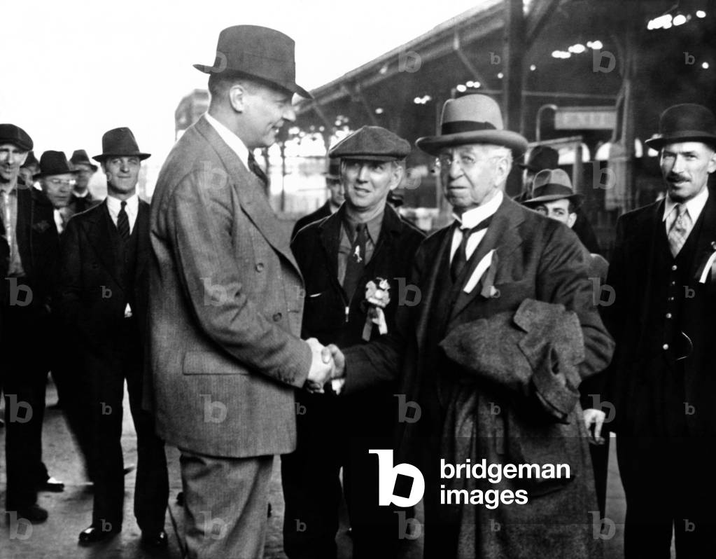The Migratory and Itinerant Workers Union, the Hobos of America, held their annual convention in Altoona, Pa. J.E. Holtzinger, of the Altoona Chamber of Commerce, greeting General Coxey(right), as Jeff Davis, Emperor of the Hobos (center), looks on. April 15, 1938
