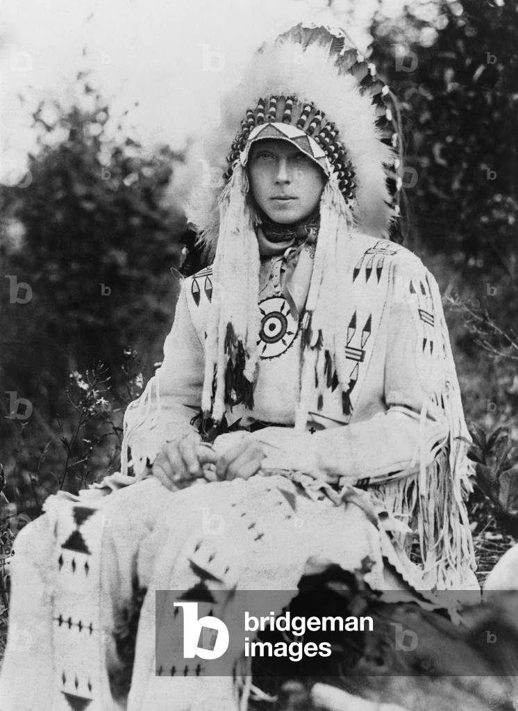 Britain's King Edward VIII as Prince of Wales, wearing the headdress of a Native American chief during a visit to the United States in the early 1920s