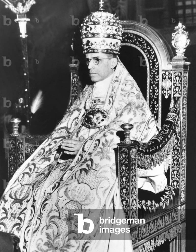 Pope Pius XII celebrated the 10th anniversary of his of his papacy at the Sistine Chapel. March 26, 1949. In full Papal Regalia, he wears the Triple Crown and a richly embroidered 'Cope', a liturgical vestment, fastened with a highly ornamented, clasp called a 'Morse'. The Pontiff is 'Sedia Gestatoria,' a portable throne carried by twelve footmen