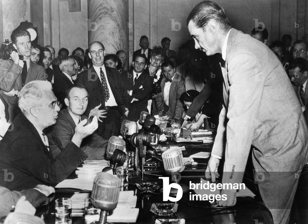 Howard Hughes (right) confers with Senator Homer Ferguson, chairman of the Senate War Investigation subcommittee, 1947