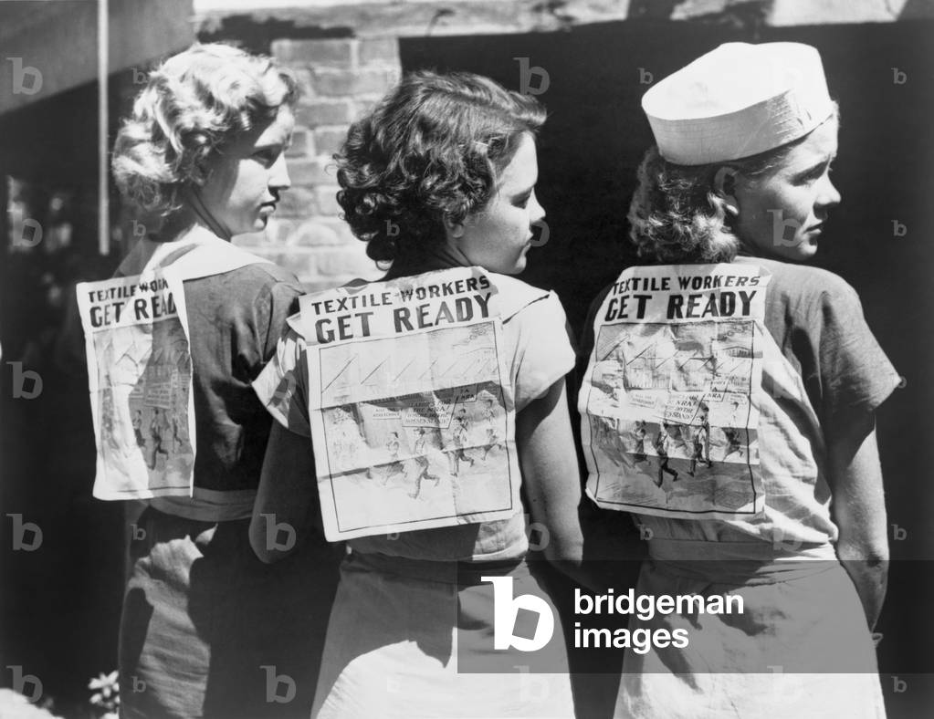 Textile workers displaying picket signs pinned on their backs during Labor Day demonstration in Gastonia, N.C. 1934