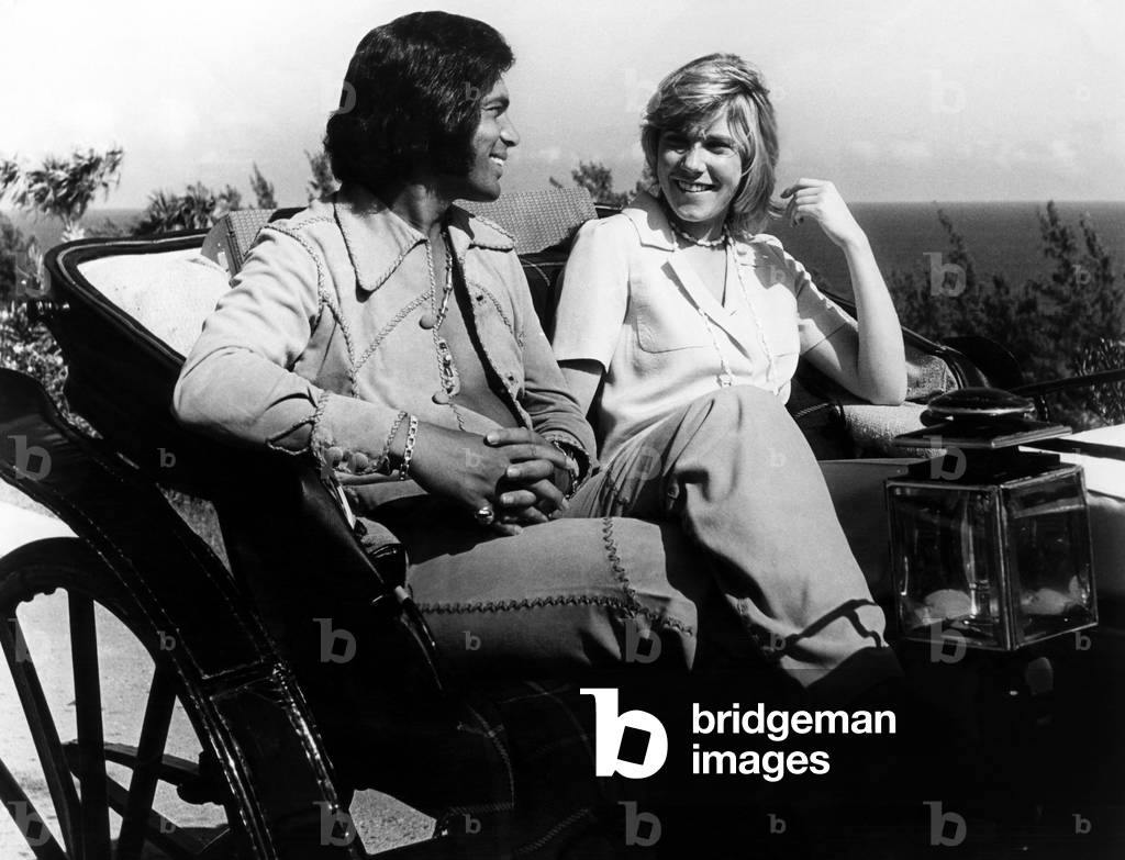 Englebert Humperdinck and Ann Murray take a ride in an old-fashioned buggy in Bermuda. c. 1974