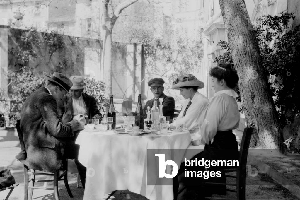 Francis Picabia (1879-1953), French painter, (center) with friends at an outdoor café. c. 1915