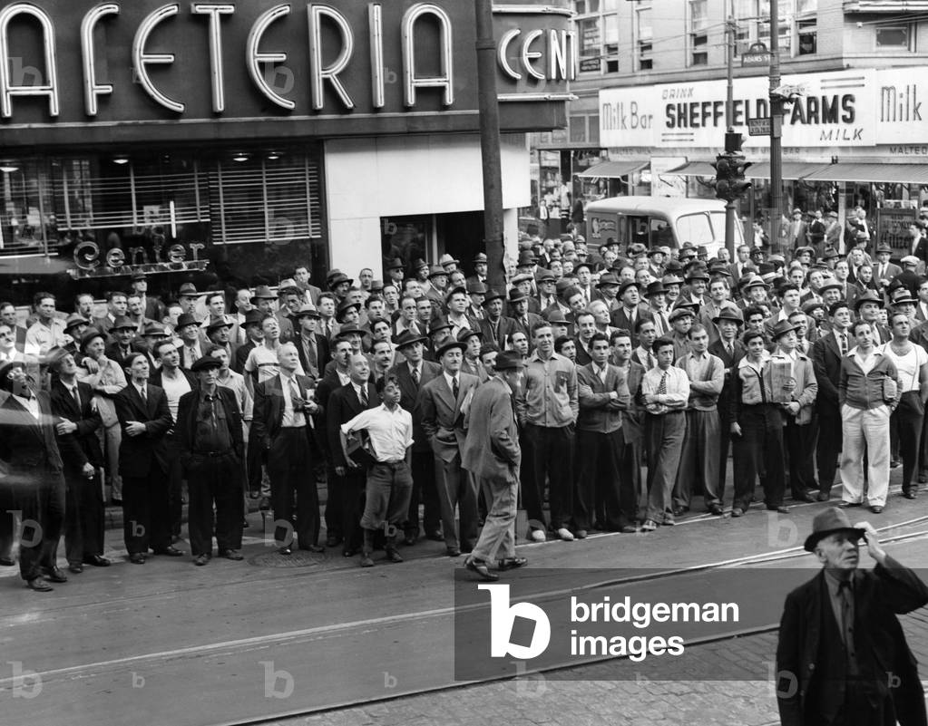 Fans watch bulletins posted by a Brooklyn newspaper as the Brooklyn Dodgers win their first National League pennant in 21 years, September 25, 1941