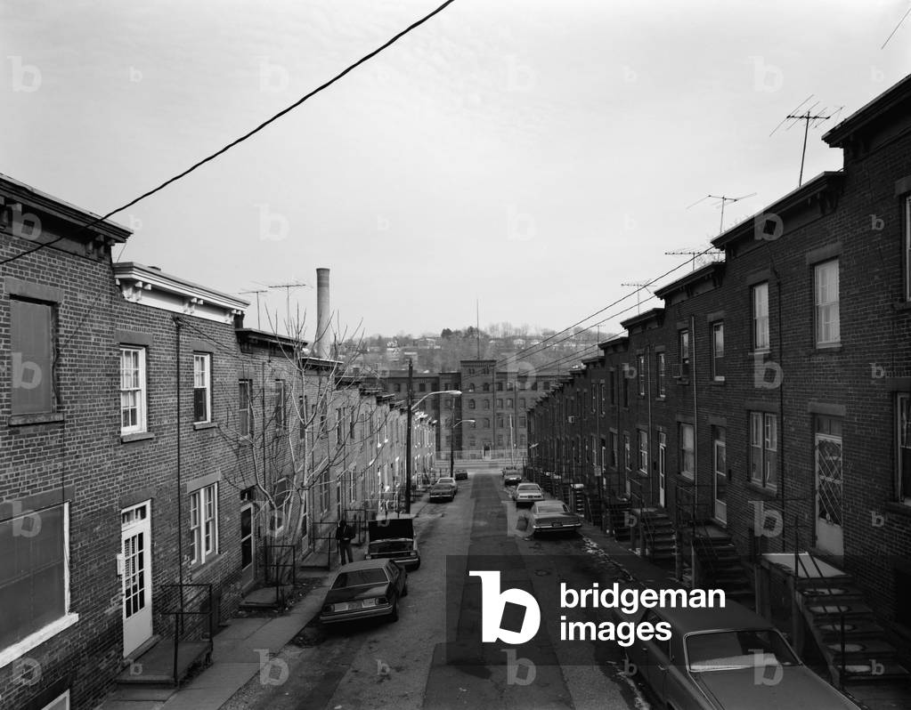 Yonkers, New York, c. 1980. Moquette Row Housing, were built by the Moquette Textile Mills for workers after a lengthy strike in 1885. View east showing front elevation